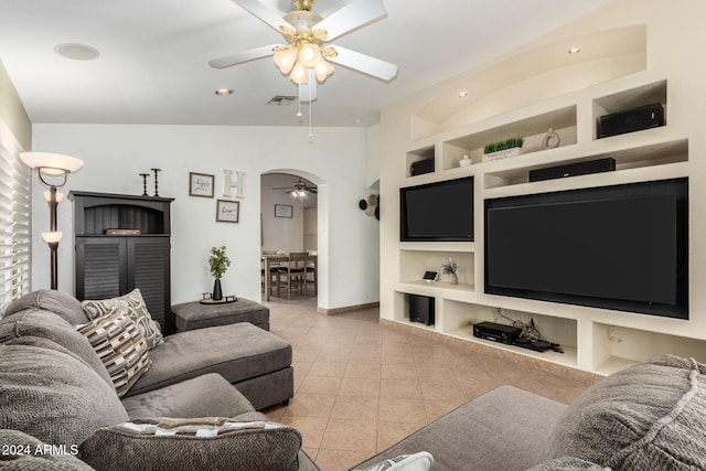 living room featuring built in features, arched walkways, light tile patterned floors, visible vents, and ceiling fan