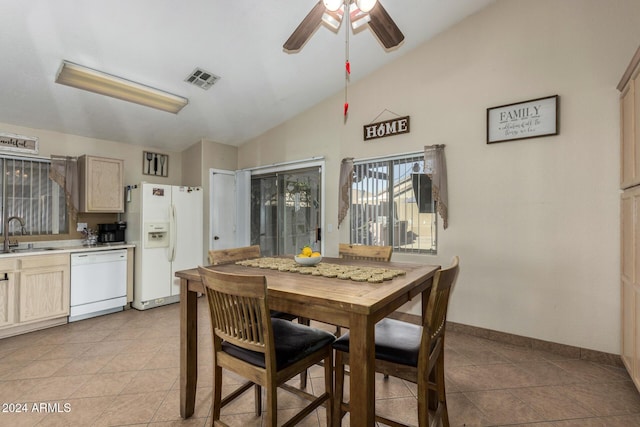 dining room with lofted ceiling, ceiling fan, baseboards, and light tile patterned flooring