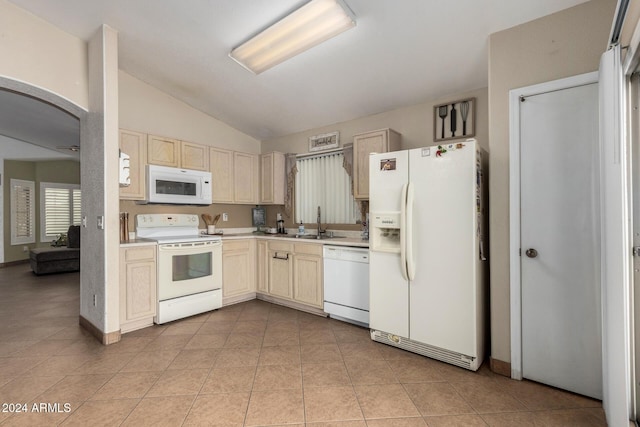 kitchen featuring white appliances, light tile patterned floors, light countertops, and a sink