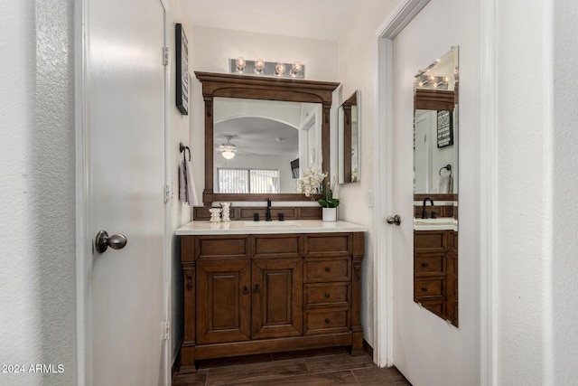 bathroom with wood tiled floor, a ceiling fan, and vanity