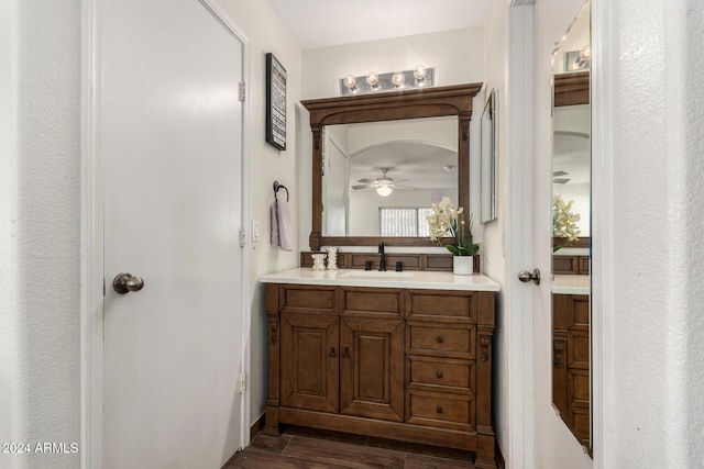 bathroom with ceiling fan, wood finished floors, and vanity