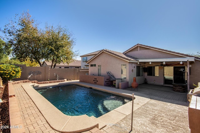 view of swimming pool with ceiling fan, a patio, a fenced backyard, and a fenced in pool