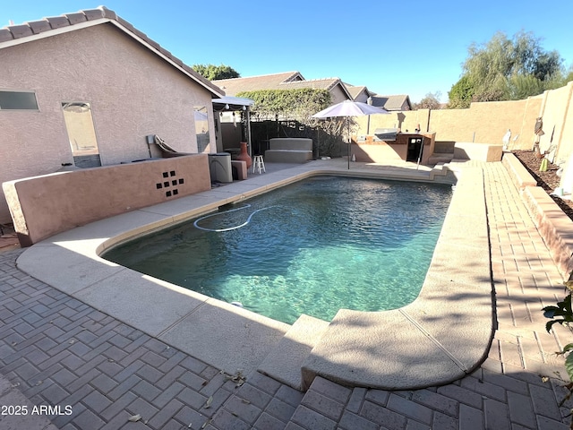 view of swimming pool with a fenced backyard, a fenced in pool, and a patio