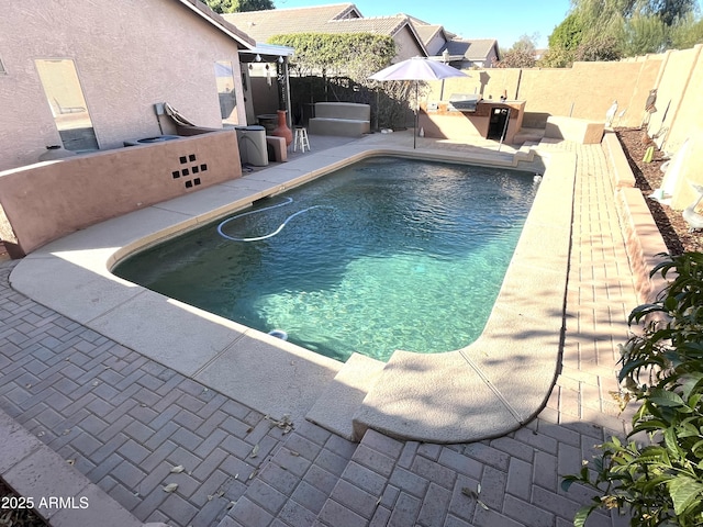 view of swimming pool featuring a patio, a fenced backyard, and a fenced in pool