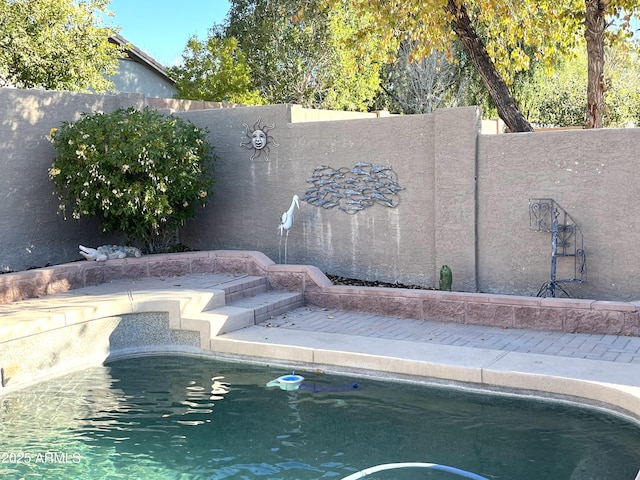 view of swimming pool with a fenced backyard and a fenced in pool