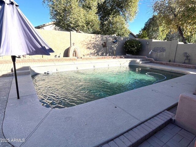 view of pool featuring a fenced in pool and a fenced backyard