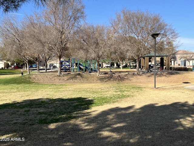 view of community with a gazebo, a lawn, and playground community