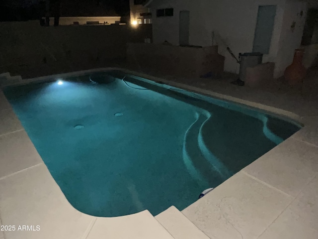 view of swimming pool with a fenced in pool
