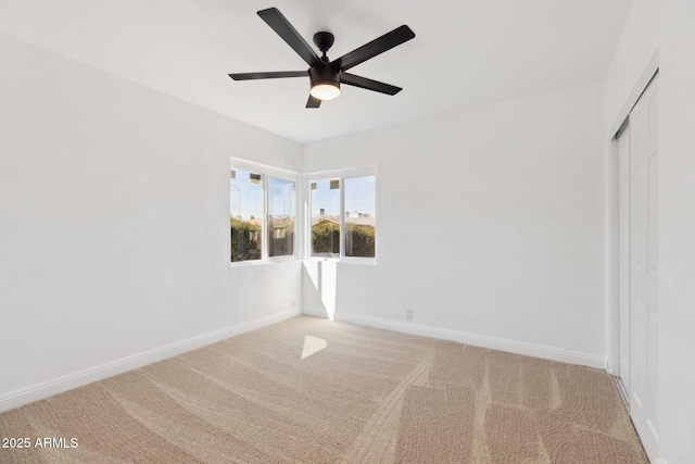 interior space featuring a ceiling fan, carpet flooring, baseboards, and a closet