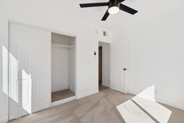 unfurnished bedroom with a closet, visible vents, a ceiling fan, and carpet floors