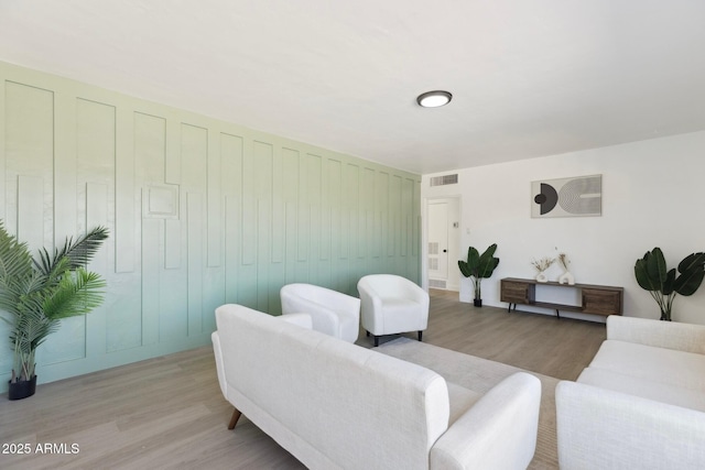 living room with visible vents and light wood-style floors