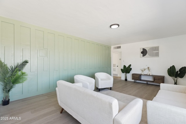 living area with visible vents and light wood-style flooring