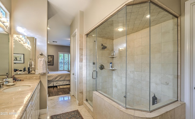 bathroom featuring vanity, a shower with door, and tile patterned flooring