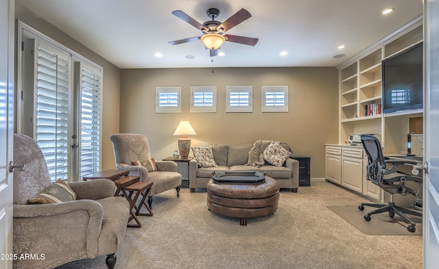 office with ceiling fan, light colored carpet, and built in features