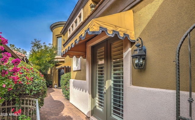 view of exterior entry featuring french doors