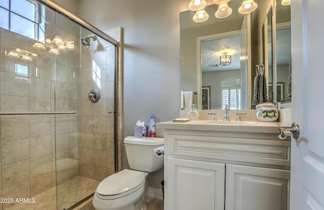 bathroom with walk in shower, vanity, and toilet