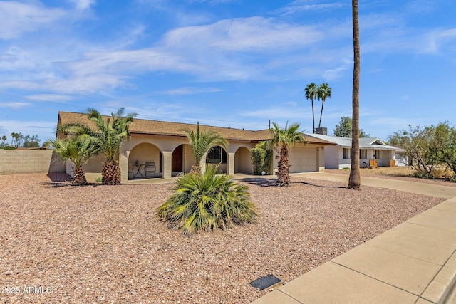 view of front of home featuring an attached garage, driveway, and stucco siding
