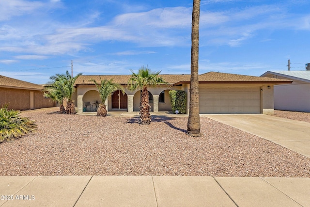 view of front of property featuring a garage, driveway, stucco siding, and covered porch