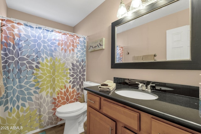 full bath with vanity, wood finished floors, toilet, and curtained shower