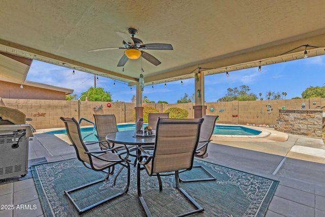 view of patio / terrace featuring a fenced backyard, a ceiling fan, grilling area, and outdoor dining area