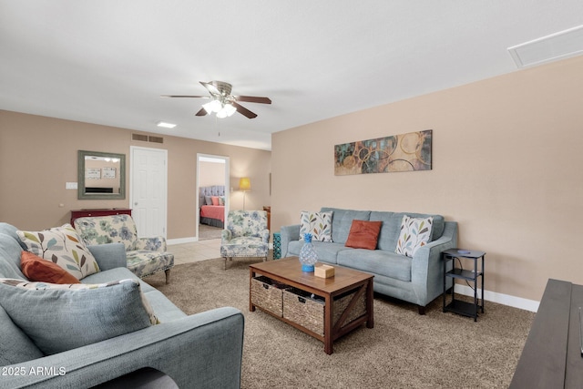 living room with ceiling fan, carpet flooring, and baseboards
