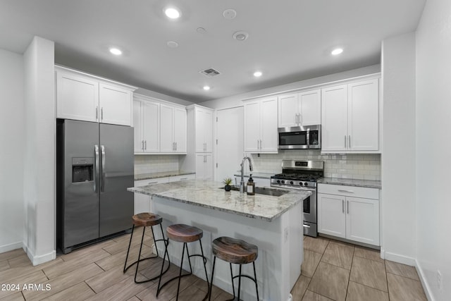 kitchen featuring sink, white cabinets, and appliances with stainless steel finishes