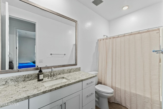 full bathroom featuring shower / tub combo, vanity, toilet, and hardwood / wood-style floors