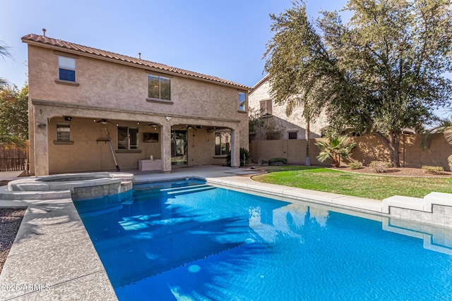 view of pool with an in ground hot tub, ceiling fan, and a patio