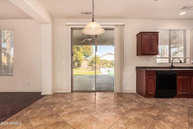 kitchen featuring tile patterned flooring, dishwasher, sink, and decorative light fixtures