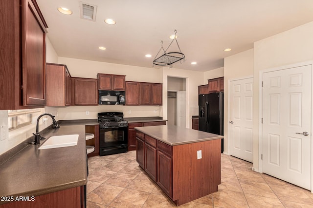 kitchen featuring sink, black appliances, and a kitchen island