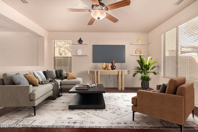 living room with a healthy amount of sunlight and ceiling fan