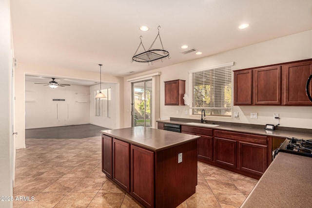 kitchen with sink, range, dishwasher, a kitchen island, and pendant lighting