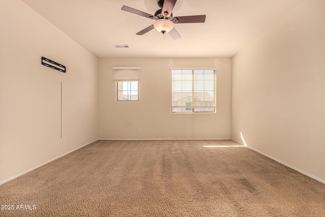 carpeted spare room featuring ceiling fan