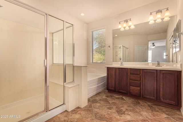 bathroom featuring vanity and independent shower and bath