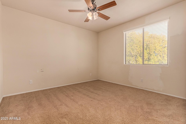 carpeted empty room featuring ceiling fan