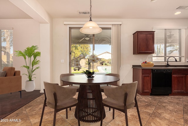 tiled dining area featuring sink and a wealth of natural light