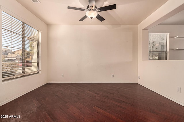 unfurnished room with dark wood-type flooring and ceiling fan