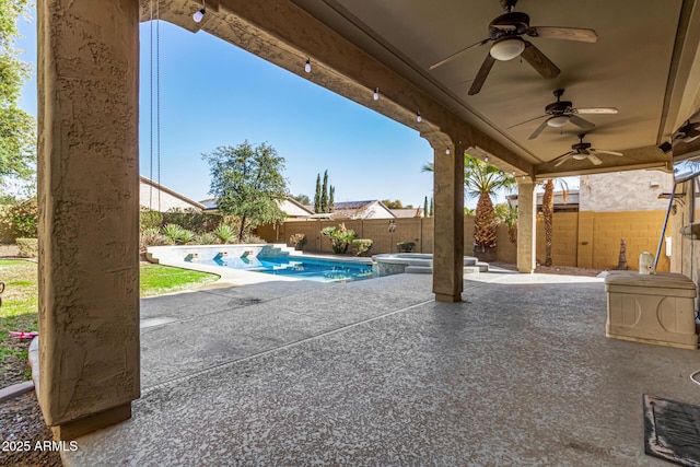 view of patio / terrace featuring a swimming pool with hot tub and ceiling fan