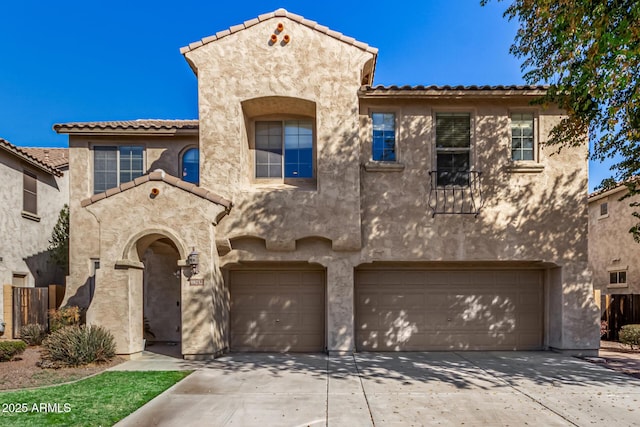 mediterranean / spanish-style house with a garage