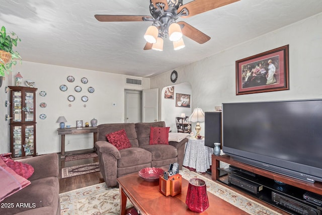 living room featuring hardwood / wood-style flooring and ceiling fan