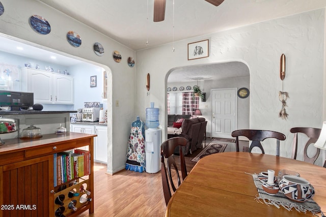 dining space featuring ceiling fan and light hardwood / wood-style flooring