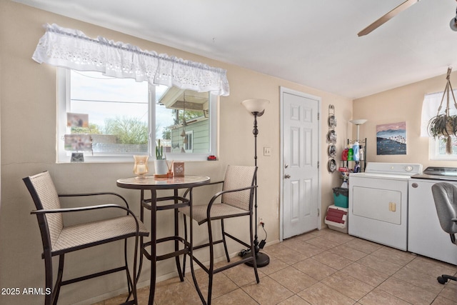 tiled dining space featuring washer and clothes dryer