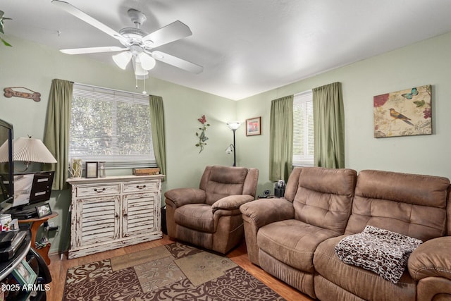 living room featuring ceiling fan and light wood-type flooring