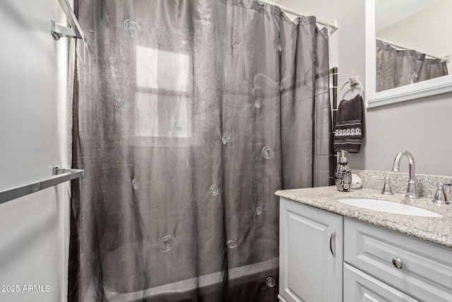 bathroom featuring vanity and shower / bath combo with shower curtain