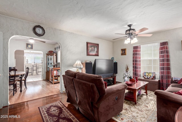 living room featuring ceiling fan and hardwood / wood-style floors