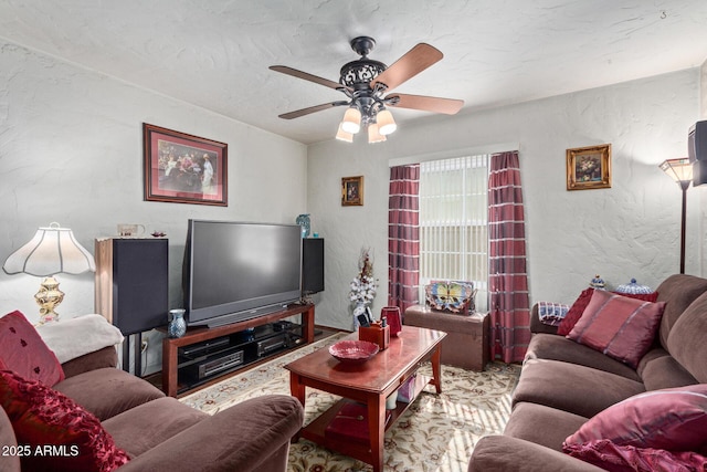 living room featuring a textured ceiling and ceiling fan