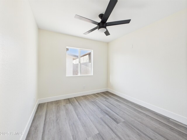 1917 E Monroe St, Phoenix, AZ 85034 - spare room with wood finished floors, baseboards, and a ceiling fan