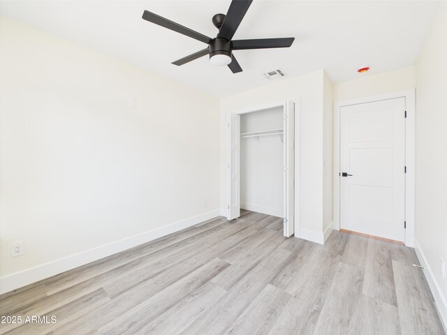 1917 E Monroe St, Phoenix, AZ 85034 - unfurnished bedroom featuring light wood finished floors, a closet, baseboards, and a ceiling fan