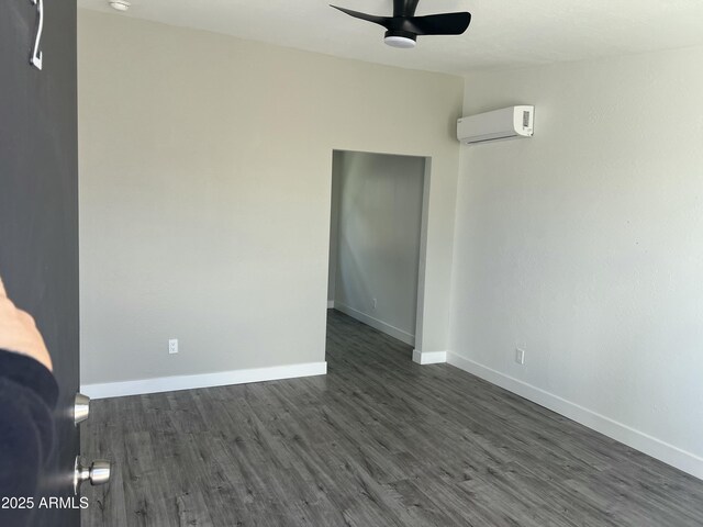1917 E Monroe St, Phoenix, AZ 85034 - spare room featuring a wall mounted AC, ceiling fan, baseboards, dark wood-style flooring, and a smoke detector