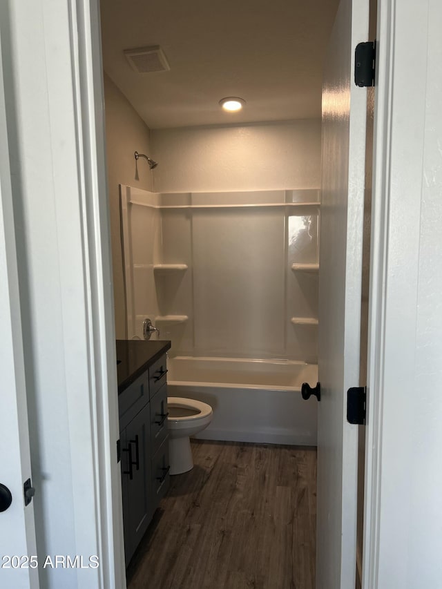 1917 E Monroe St, Phoenix, AZ 85034 - full bath with wood finished floors, vanity, toilet, and bathing tub / shower combination